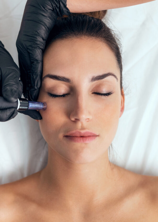 Cosmetologist making mesotherapy injection with dermapen on face